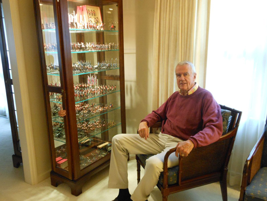 James A. Henderson, retired chairman and CEO of Cummins Engine Co. Inc., at home with prized pieces from his collection displayed in a showcase. Old Toy Soldier Auctions image